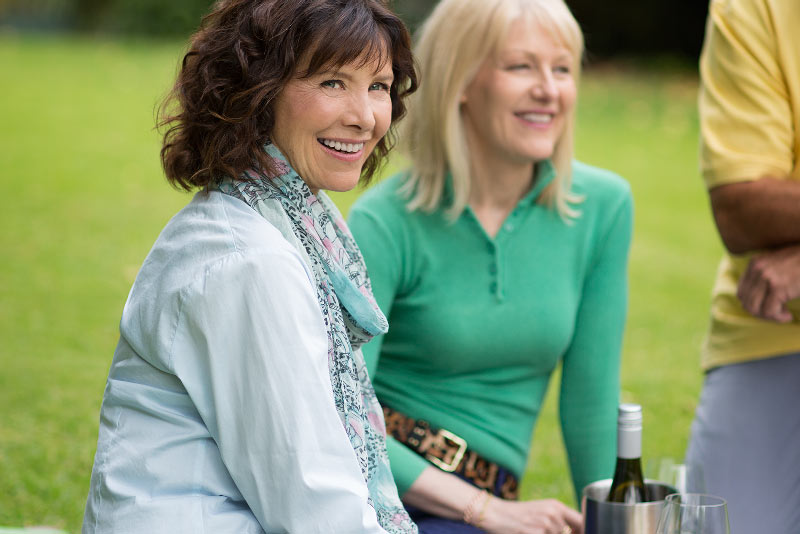 Woman with hearing loss and aids at picnic
